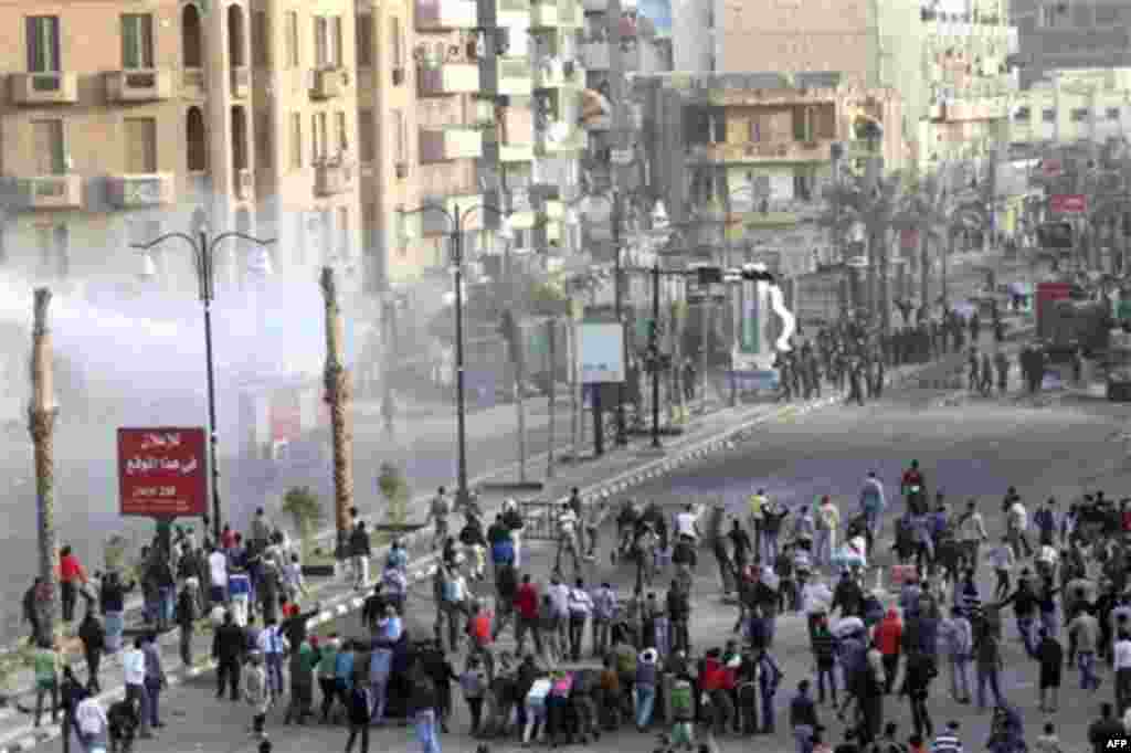 Egyptians protestors clash with anti-riot policemen in Suez, Egypt, Thursday, Jan.27, 2011. Egyptian activists protested for a third day as social networking sites called for a mass rally in the capital Cairo after Friday prayers, keeping up the momentum 