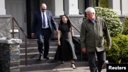 FILE - Huawei's Meng Wanzhou leaves her family home flanked by private security in Vancouver, British Columbia, May 8, 2019.