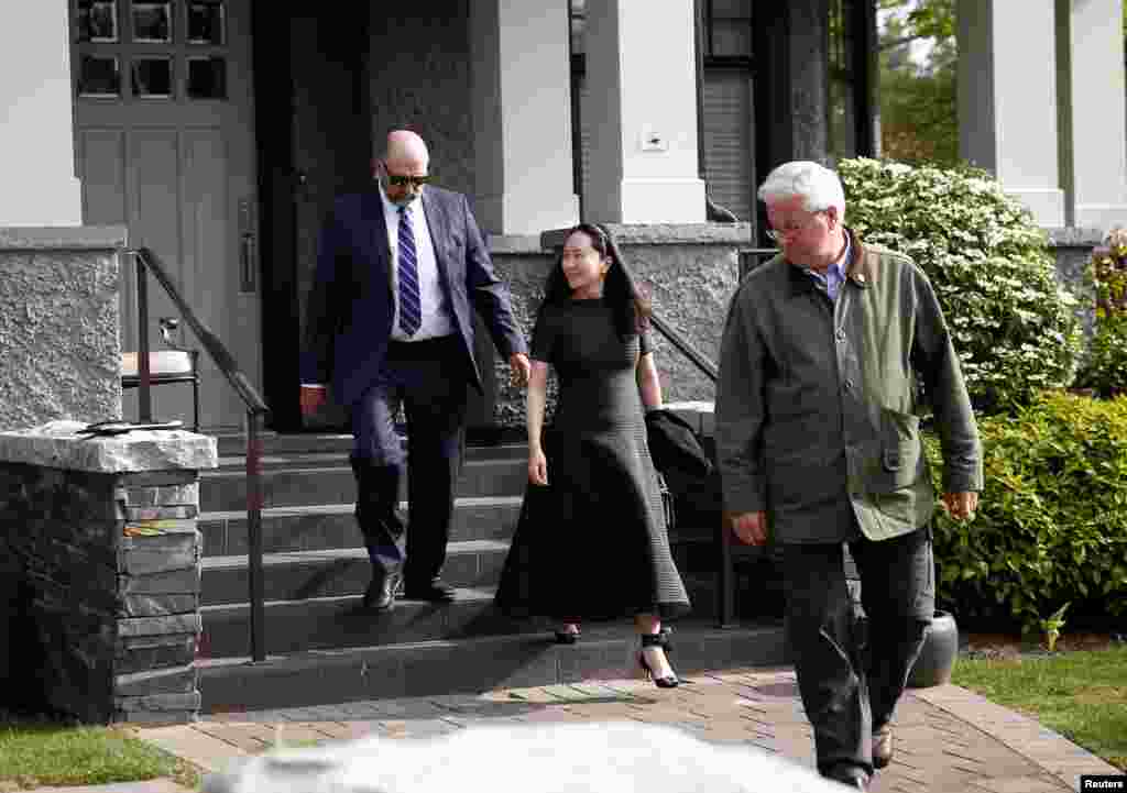 Huawei&#39;s Financial Chief Meng Wanzhou wearing an ankle monitor, leaves her family home with her private security in Vancouver, British Columbia, Canada, May 8, 2019.