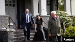 Huawei's Financial Chief Meng Wanzhou leaves her family home flanked by private security in Vancouver, British Columbia, Canada, May 8, 2019. 