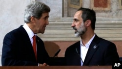 U.S. Secretary of State John Kerry shakes hands with Syrian National Coalition President Mouaz al-Khatib, after a news conference at Villa Madama in Rome, February 28, 2013. 