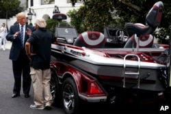 President Donald Trump talks with Jimmy Houston of Ranger Boats as he participates in a tour during a "Made in America Product Showcase" at the White House, July 23, 2018.