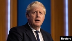 FILE - Britain's Prime Minister Boris Johnson holds a news conference on a winter COVID-19 plan in the Downing Street Briefing Room in London, Sept. 14, 2021.
