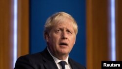 FILE - Britain's Prime Minister Boris Johnson holds a news conference on a winter COVID-19 plan in the Downing Street Briefing Room in London, Sept. 14, 2021.