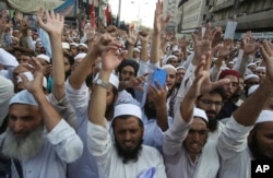 FILE - Radical Islamists rally to condemn a Supreme Court decision that acquitted Asia Bibi, a Christian woman, who spent eight years on death row accused of blasphemy, in Karachi, Pakistan, Nov. 1, 2018.