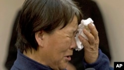 A relative of Chinese passengers onboard the Malaysia Airlines Flight 370, cries as she asks for answers during a meeting with Malaysia embassy and Malaysia Airlines representatives in Beijing, April 21, 2014. 
