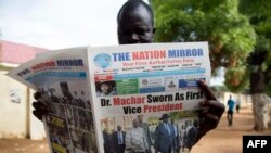 A resident reads a daily newspaper in Juba, South Sudan, April 27, 2016