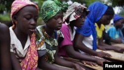 Pupils attend a koranic school in the town of Small Sefoda in eastern Sierra Leone, April 22, 2012.