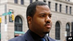 FILE - Officer William Porter, one of six Baltimore city police officers charged in connection to the death of Freddie Gray, walks into a courthouse during jury deliberations, Dec. 16, 2015, in Baltimore.