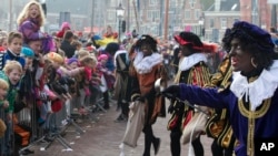 The Dutch version of Santa Claus, Sinterklaas, or Saint Nicholas, and his blackface helpers Zwarte Piet (Black Pete) arrive by steamboat in Hoorn, northwestern Netherlands, Nov. 16, 2013.
