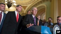 FILE - Senate Republican Majority Leader Mitch McConnell, center, joined by Republican colleagues, holds a news conference on Capitol Hill, in Washington, Aug. 1, 2017.