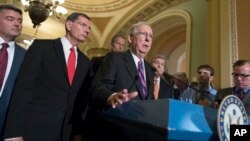 FILE - Senate Republican Majority Leader Mitch McConnell, center, joined by Republican colleagues, holds a news conference on Capitol Hill, in Washington, Aug. 1, 2017. McConnell says it's not even certain there will be a repeal vote.