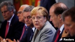 German Chancellor Angela Merkel attends a news conference after meeting with chairmen of international economic and financial organizations at the Chancellery in Berlin, Germany, Oct. 1, 2019. 