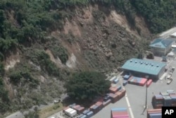 This image made from a video shows a landslide near an international shipping terminal in Port Vila, Vanuatu, following a powerful earthquake, Dec. 17, 2024.