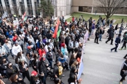 FILE - Tamika Palmer, mother of Breonna Taylor, and others lead a memorial march for Breonna Taylor near Jefferson Square Park on March 13, 2021 in Louisville, Kentucky.