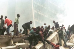 FILE - An injured man is removed from the wreckage after an explosion near the U.S. Embassy in Nairobi on Aug. 7, 1998.