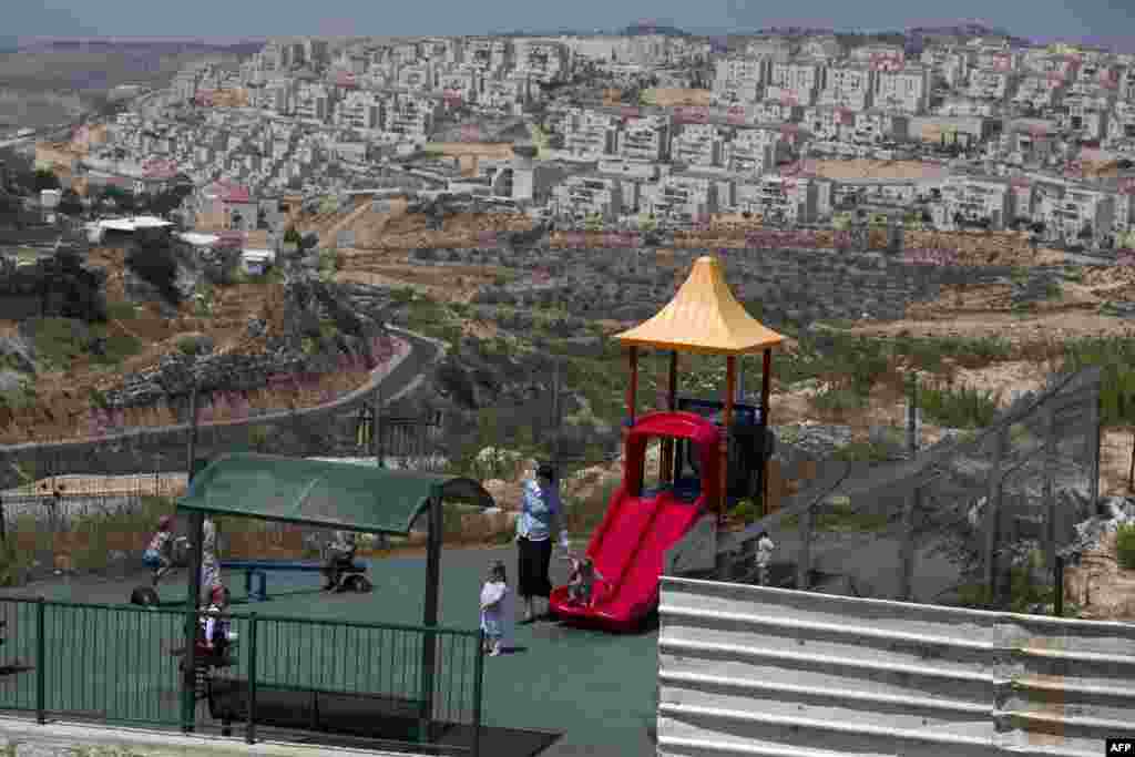 A Jewish woman looks after children at a playground in the Jewish settlement of Beitar Elit at the Israeli occupied West Bank. 