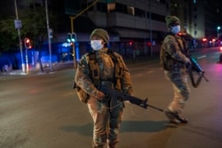 South African Defense Forces patrol downtown Johannesburg, South Africa, March 27, 2020 amid a 21-day coronavirus lockdown.