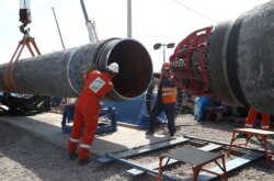 FILE - Workers are seen at the construction site of the Nord Stream 2 gas pipeline, near the town of Kingisepp, Leningrad region, Russia, June 5, 2019.