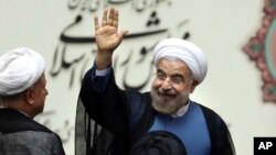 Iran's new President Hassan Rouhani, waves after swearing in at the parliament, in Tehran, Iran, Aug. 4, 2013.