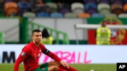 FILE - Portugal's Cristiano Ronaldo sits on the pitch during a soccer match between Portugal and Spain at the Jose Alvalade stadium in Lisbon, Oct. 7, 2020.