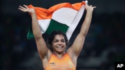 India's Sakshi Malik reacts after winning bronze against Kyrgyzstan's Aisuluu Tynybekova in the Women's Wrestling Freestyle 58-kg Competition at the 2016 Summer Olympics in Rio de Janeiro, Brazil, Aug. 17, 2016.