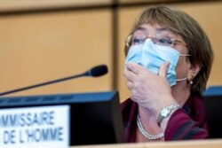 FILE - United Nations' High Commissioner for Human Rights Michelle Bachelet adjusts her mask during the 45th session of the Human Rights Council, at the European U.N. headquarters in Geneva, Switzerland, Sept. 14, 2020.