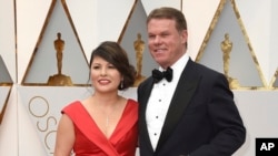 FILE - Accountants Martha Ruiz and Brian Cullinan from PricewaterhouseCoopers are pictured at the Oscars in Los Angeles, Feb. 26, 2017.