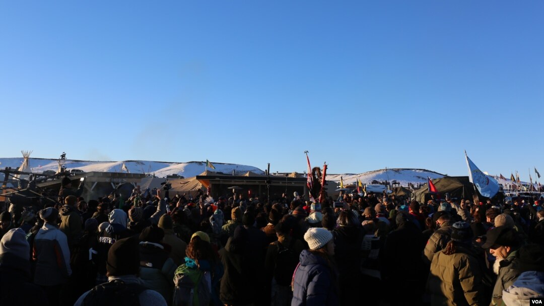 Water protectors celebrate the decision of the Army Corps to deny the building of the Dakota Access Oil Pipeline through their and sacred Sioux land (E. Sarai/VOA)
