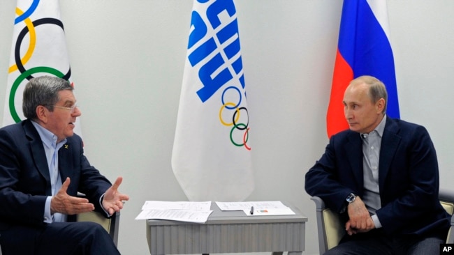 FILE - In this Feb. 15, 2014 file photo Russian President Vladimir Putin, right, and IOC President Thomas Bach meet in the Bolshoi Ice Dome in Sochi, Russia. (RIA-Novosti, Mikhail Klimentyev, Presidential Press Service via AP, file)