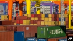 FILE - Shipping containers are stacked at a port in Tianjin, China, Jan. 16, 2023. U.S. President Donald Trump said Tuesday tthat a 10% duty on Chinese imports could come as soon as February 1. 