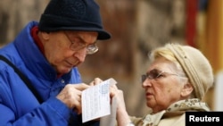 Voters at a polling station during the second round of a presidential election in Kyiv, Ukraine April 21, 2019. 