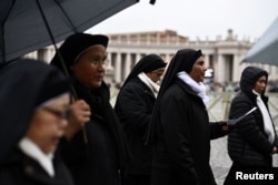 Nuns arrive to pray at St. Peter's Square, as Pope Francis continues his hospitalization, at the Vatican on March 1, 2025.