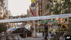 New York Police Department officers investigate at the scene of an attack in Manhattan's Chinatown neighborhood, Oct. 5, 2019 in New York.