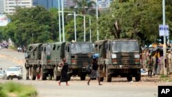 FILE - Zimbabwe soldiers are placed where police are clashing with protesters over fuel hikes in Harare, Jan. 14, 2019.