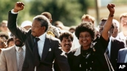 FILE - In this Feb. 11, 1990 file photo, Nelson Mandela and his wife, Winnie Madikizela-Mandela, raise clenched fists as they walk hand-in-hand upon his release from prison in Cape Town, South Africa. (AP Photo/Greg English, File)