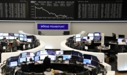FILE - The German share price index DAX graph is pictured at the stock exchange in Frankfurt, Germany, Aug. 14, 2019.