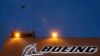 FILE - An airplane flies over a sign on Boeing's 737 delivery center, Oct. 19, 2015, at Boeing Field in Seattle. 