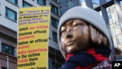 A statue symbolizing a wartime sex slave is displayed near the Japanese Embassy in Seoul, South Korea, Friday, Jan. 8, 2021. A South Korean court on Friday ordered Japan to financially compensate 12 South Korean women forced to work as sex slaves…