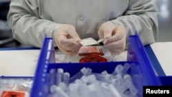 A technician assembles coronavirus test kits at the Evolve manufacturing facility in Fremont, Calif., March 26, 2020. The U.S. is seeing Russian, Chinese and Iranian COVID-19 disinformation campaigns converging, a State Department official says.