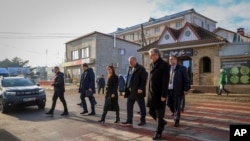 FILE - Moldovan President Maia Sandu crosses a road during a visit to areas affected by gas and electricity shortages, in Varnita, Moldova, on Jan. 9, 2025. Sandu traveled to Ukraine on Jan. 25, 2025, to discuss energy, among other issues.