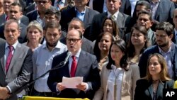Venezuela's National Assembly President Julio Borges, center, surrounded by fellow legislators, speaks during a meeting with the media, in Caracas, Venezuela, April 18, 2017.