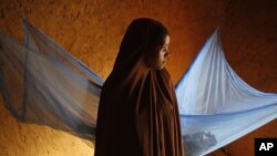 FILE - Zali Idy, 12, poses in her bedroom in the remote village of Hawkantaki, Niger, July 18, 2012. Zali was married in 2011. 