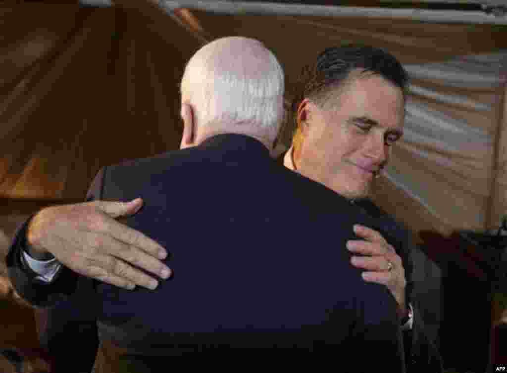 Republican presidential candidate, former Massachusetts Gov. Mitt Romney embraces Sen. John McCain, R-Ariz., as Romney introduced him at a campaign event, Friday, Jan. 6, 2012, in Conway, S.C. (AP Photo/David Goldman)