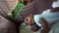 Jackeline, 26, uses a green bottle to stimulate to her son Daniel who is 4-months old and born with microcephaly, inside of their house in Olinda, near Recife, Brazil, Feb. 11, 2016. 