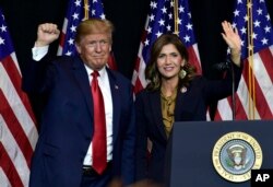 FILE - President Donald Trump appears with South Dakota Gov. Kristi Noem, Sept. 7, 2018.