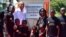 Former US President, Barack Obama (2L) poses for a photograph with local young beneficiaries on July 16, 2018 during the opening of the Sauti Kuu Resource Centre, founded by his half-sister, Auma Obama (3R) at Kogelo in Siaya county, western Kenya.