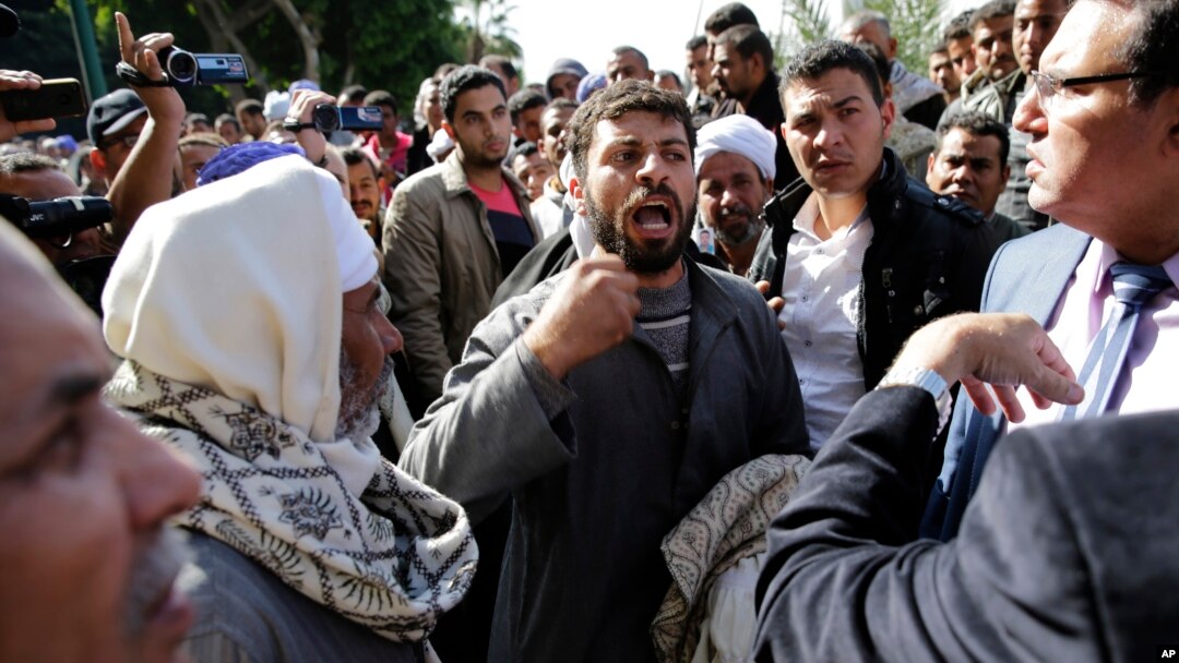 FILE - Coptic Christian men whose relatives were abducted in Libya leave the Egyptian Foreign Ministry in Cairo, Jan. 19, 2015.