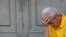 A pensioner waits in front of the main entrance of a National Bank branch to receive part of his pension in central Athens, July 9, 2015. 