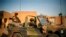 FILE - French soldiers secure the evacuation of foreigners during exchanges of fire in Gao, northern Mali, Feb. 10, 2013.